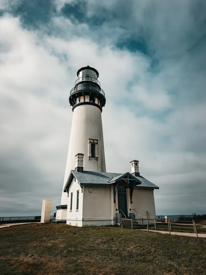 Yaquina Head Lighthouse under a big coastal sky.
